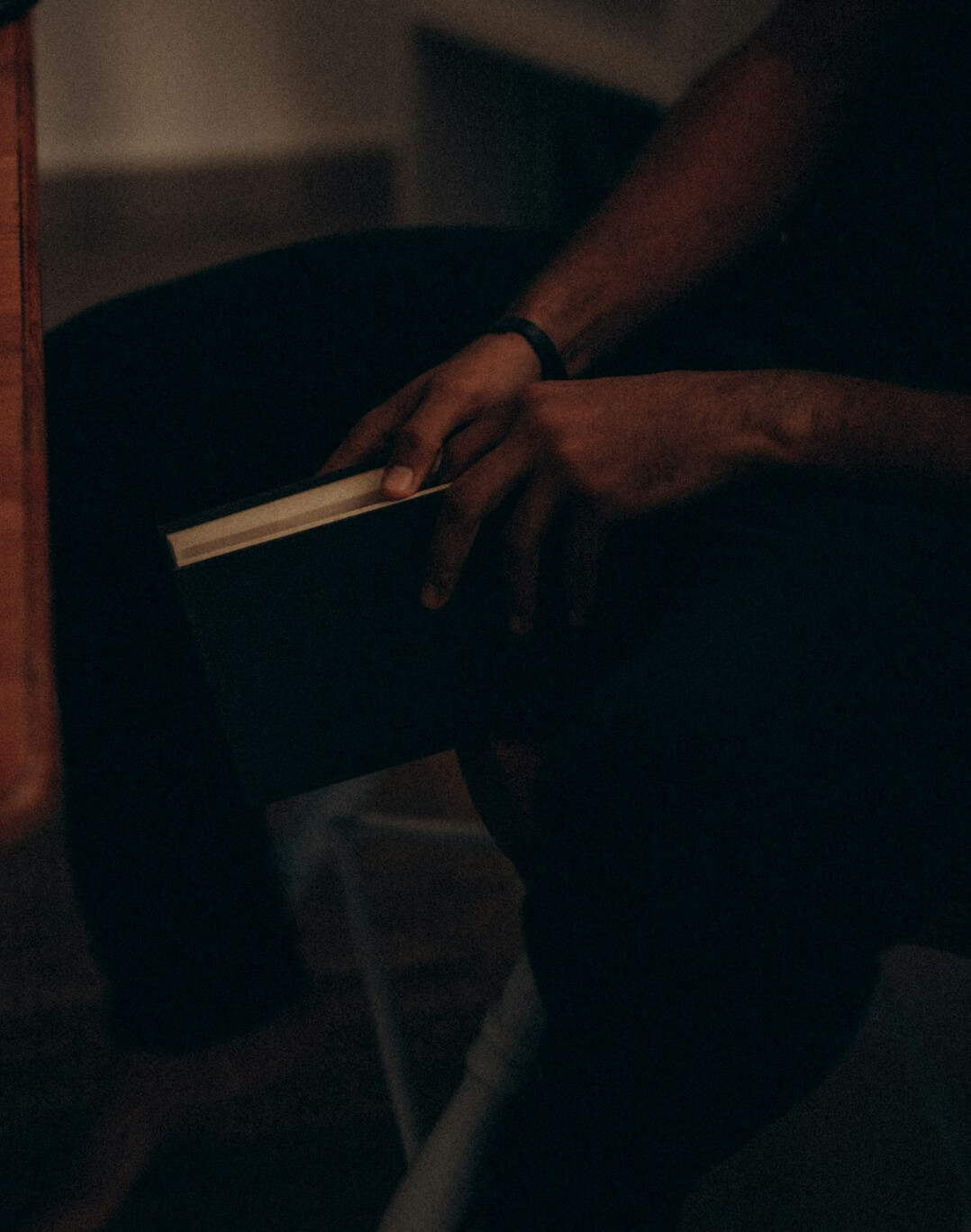 person reading book at home